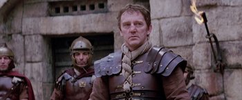 Movie still from “The Passion of the Christ” (2004), directed by Mel Gibson – Two men in medieval costumes standing next to each other; Close Up shot, Low angle