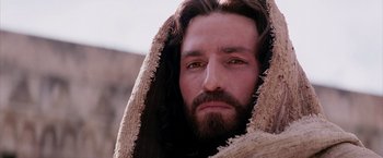 Movie still from “The Passion of the Christ” (2004), directed by Mel Gibson – A person with a beard wearing a robe; Close Up shot, Low angle