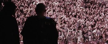Movie still from “The Passion of the Christ” (2004), directed by Mel Gibson – A man standing in front of a crowd of people; Wide shot, High angle