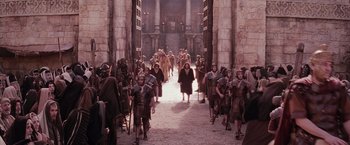 Movie still from “The Passion of the Christ” (2004), directed by Mel Gibson – A crowd of people walking down a street; Extreme Wide shot, High angle