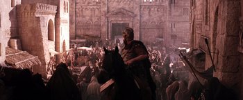 Movie still from “The Passion of the Christ” (2004), directed by Mel Gibson – A man riding a horse in a crowd of people; Extreme Wide shot, Low angle