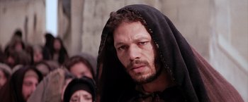 Movie still from “The Passion of the Christ” (2004), directed by Mel Gibson – A person wearing a hood; Close Up shot, Low angle