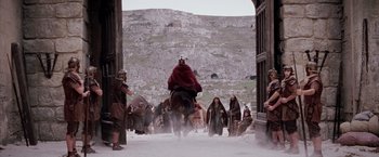 Movie still from “The Passion of the Christ” (2004), directed by Mel Gibson – A group of people dressed in medieval clothing riding on horses; Extreme Wide shot, Low angle