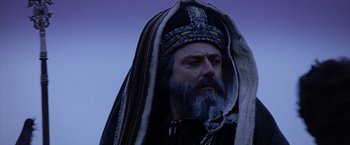 Movie still from “The Passion of the Christ” (2004), directed by Mel Gibson – A man with a beard and a long beard wearing a hat; Close Up shot, Low angle