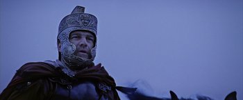 Movie still from “The Passion of the Christ” (2004), directed by Mel Gibson – A man in a roman soldier's helmet and armor; Close Up shot, Low angle