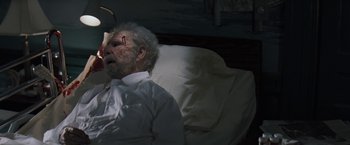 Movie still from “The Pelican Brief” (1993), directed by Alan J. Pakula – An old man in a hospital bed with a cut head; Close Up shot, High angle