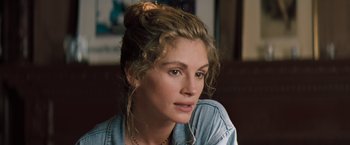 Movie still from “The Pelican Brief” (1993), directed by Alan J. Pakula – A person wearing a blue shirt; Close Up shot, Over the shoulder angle