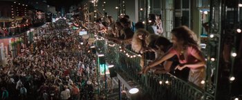 Movie still from “The Pelican Brief” (1993), directed by Alan J. Pakula – A group of people on a balcony with lights; Extreme Wide shot, High angle