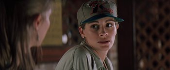 Movie still from “The Pelican Brief” (1993), directed by Alan J. Pakula – A person wearing a hat; Close Up shot, Over the shoulder angle