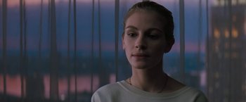 Movie still from “The Pelican Brief” (1993), directed by Alan J. Pakula – A young woman is standing in front of a window; Close Up shot, Low angle