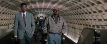 Movie still from “The Pelican Brief” (1993), directed by Alan J. Pakula – A man standing in a tunnel with his hands in his pockets; Medium shot, Low angle