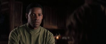 Movie still from “The Pelican Brief” (1993), directed by Alan J. Pakula – A person wearing a green shirt; Close Up shot, Over the shoulder angle