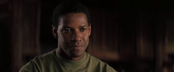 Movie still from “The Pelican Brief” (1993), directed by Alan J. Pakula – A person wearing a green shirt; Close Up shot, Over the shoulder angle