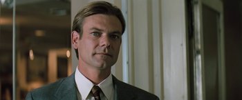 Movie still from “The Pelican Brief” (1993), directed by Alan J. Pakula – A person wearing a suit and tie; Close Up shot, Low angle