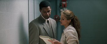 Movie still from “The Pelican Brief” (1993), directed by Alan J. Pakula – A man and a woman are looking at each other; Medium shot, Over the shoulder angle