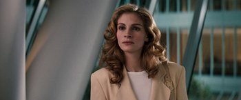 Movie still from “The Pelican Brief” (1993), directed by Alan J. Pakula – A woman in a beige jacket and white shirt; Close Up shot, Low angle