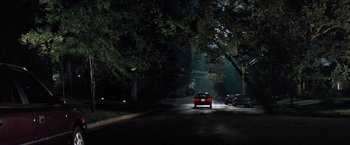 Movie still from “The Pelican Brief” (1993), directed by Alan J. Pakula – A car driving down a street at night; Extreme Wide shot, High angle