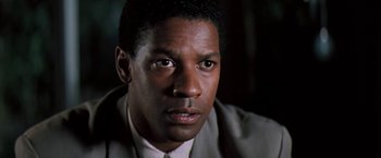 Movie still from “The Pelican Brief” (1993), directed by Alan J. Pakula – A person wearing a suit and tie; Close Up shot, Low angle