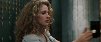 Movie still from “The Pelican Brief” (1993), directed by Alan J. Pakula – A person with curly hair; Close Up shot, Over the shoulder angle