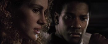 Movie still from “The Pelican Brief” (1993), directed by Alan J. Pakula – A woman and a man's face; Close Up shot, Over the shoulder angle