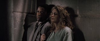 Movie still from “The Pelican Brief” (1993), directed by Alan J. Pakula – A man and a woman sitting next to each other; Close Up shot, Low angle