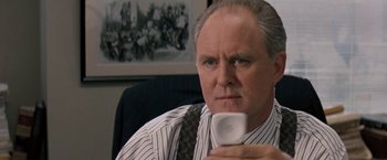 Movie still from “The Pelican Brief” (1993), directed by Alan J. Pakula – An older man holding a cell phone in his hand; Close Up shot, High angle