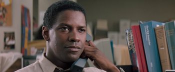 Movie still from “The Pelican Brief” (1993), directed by Alan J. Pakula – A person talking on a cell phone; Close Up shot, Low angle