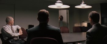 Movie still from “The Pelican Brief” (1993), directed by Alan J. Pakula – A man and a woman in a conference room; Wide shot, Over the shoulder angle