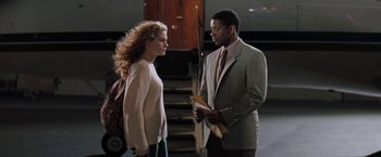 Movie still from “The Pelican Brief” (1993), directed by Alan J. Pakula – A man and a woman standing next to each other; Medium shot, Over the shoulder angle