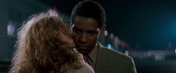 Movie still from “The Pelican Brief” (1993), directed by Alan J. Pakula – A man and a woman kissing in the dark; Close Up shot, Low angle