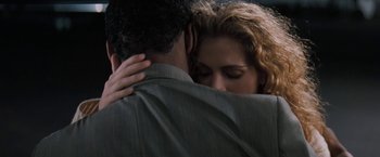 Movie still from “The Pelican Brief” (1993), directed by Alan J. Pakula – A man and a woman embracing each other; Close Up shot, Low angle