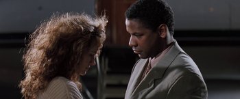 Movie still from “The Pelican Brief” (1993), directed by Alan J. Pakula – A man and a woman standing next to each other; Close Up shot, Low angle