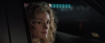 Movie still from “The Pelican Brief” (1993), directed by Alan J. Pakula – A person with curly hair; Close Up shot, Over the shoulder angle