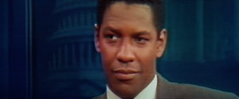 Movie still from “The Pelican Brief” (1993), directed by Alan J. Pakula – A man in a suit and tie; Close Up shot, Over the shoulder angle