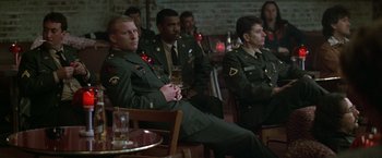 Movie still from “The People vs. Larry Flynt” (1996), directed by Milos Forman – A group of men in uniform sitting at a table; Medium shot, High angle