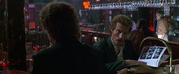 Movie still from “The People vs. Larry Flynt” (1996), directed by Milos Forman – A man sitting at a table in front of another man; Close Up shot, Over the shoulder angle