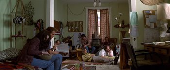 Movie still from “The People vs. Larry Flynt” (1996), directed by Milos Forman – A group of people sitting in a living room together; Wide shot, High angle