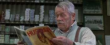 Movie still from “The People vs. Larry Flynt” (1996), directed by Milos Forman – An older man reading a magazine in a store; Close Up shot, Low angle