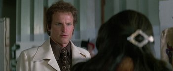 Movie still from “The People vs. Larry Flynt” (1996), directed by Milos Forman – A person wearing a suit and a tie; Close Up shot, Over the shoulder angle