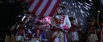 Movie still from “The People vs. Larry Flynt” (1996), directed by Milos Forman – A group of people dressed up in costumes and holding flags; Wide shot, Low angle