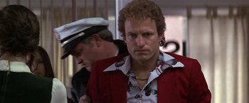 Movie still from “The People vs. Larry Flynt” (1996), directed by Milos Forman – A man in a red jacket standing next to another man in a white hat; Close Up shot, Low angle