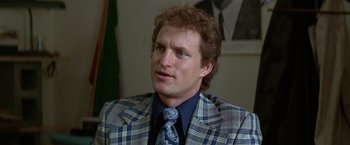 Movie still from “The People vs. Larry Flynt” (1996), directed by Milos Forman – A person wearing a suit and tie; Close Up shot, Over the shoulder angle