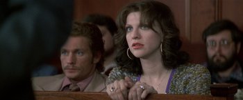 Movie still from “The People vs. Larry Flynt” (1996), directed by Milos Forman – A woman sitting next to a man in a courtroom; Close Up shot, Low angle