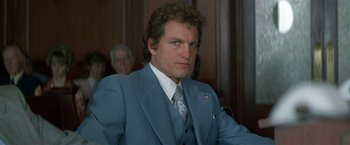 Movie still from “The People vs. Larry Flynt” (1996), directed by Milos Forman – A person wearing a suit and tie; Close Up shot, Low angle