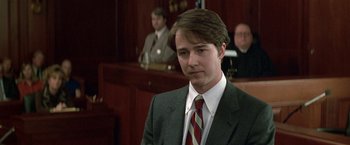 Movie still from “The People vs. Larry Flynt” (1996), directed by Milos Forman – A man wearing a suit and tie in a courtroom; Close Up shot, Low angle