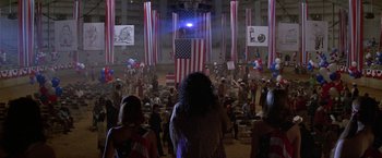 Movie still from “The People vs. Larry Flynt” (1996), directed by Milos Forman – A crowd of people standing in front of an american flag; Extreme Wide shot, High angle
