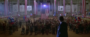 Movie still from “The People vs. Larry Flynt” (1996), directed by Milos Forman – A crowd of people in a room with american flags and balloons; Wide shot, High angle