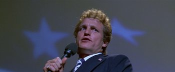Movie still from “The People vs. Larry Flynt” (1996), directed by Milos Forman – A person holding a microphone; Close Up shot, Low angle