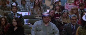 Movie still from “The People vs. Larry Flynt” (1996), directed by Milos Forman – A crowd of people sitting and standing in a room; Medium shot, High angle