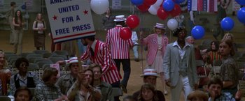 Movie still from “The People vs. Larry Flynt” (1996), directed by Milos Forman – A group of people dressed in red , white , and blue; Medium shot, High angle